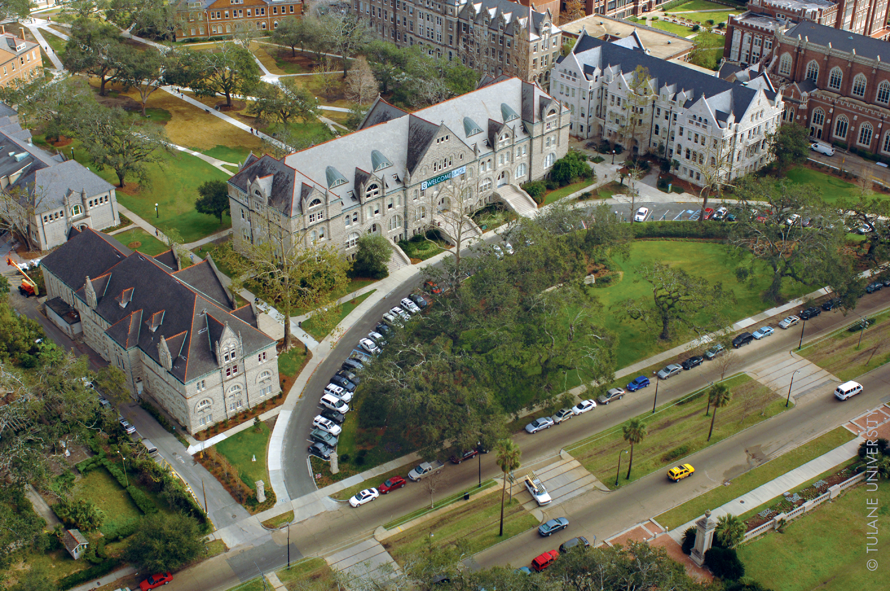An aerial view of a university campus showing academic buildings, quads, and tree-lined grounds.