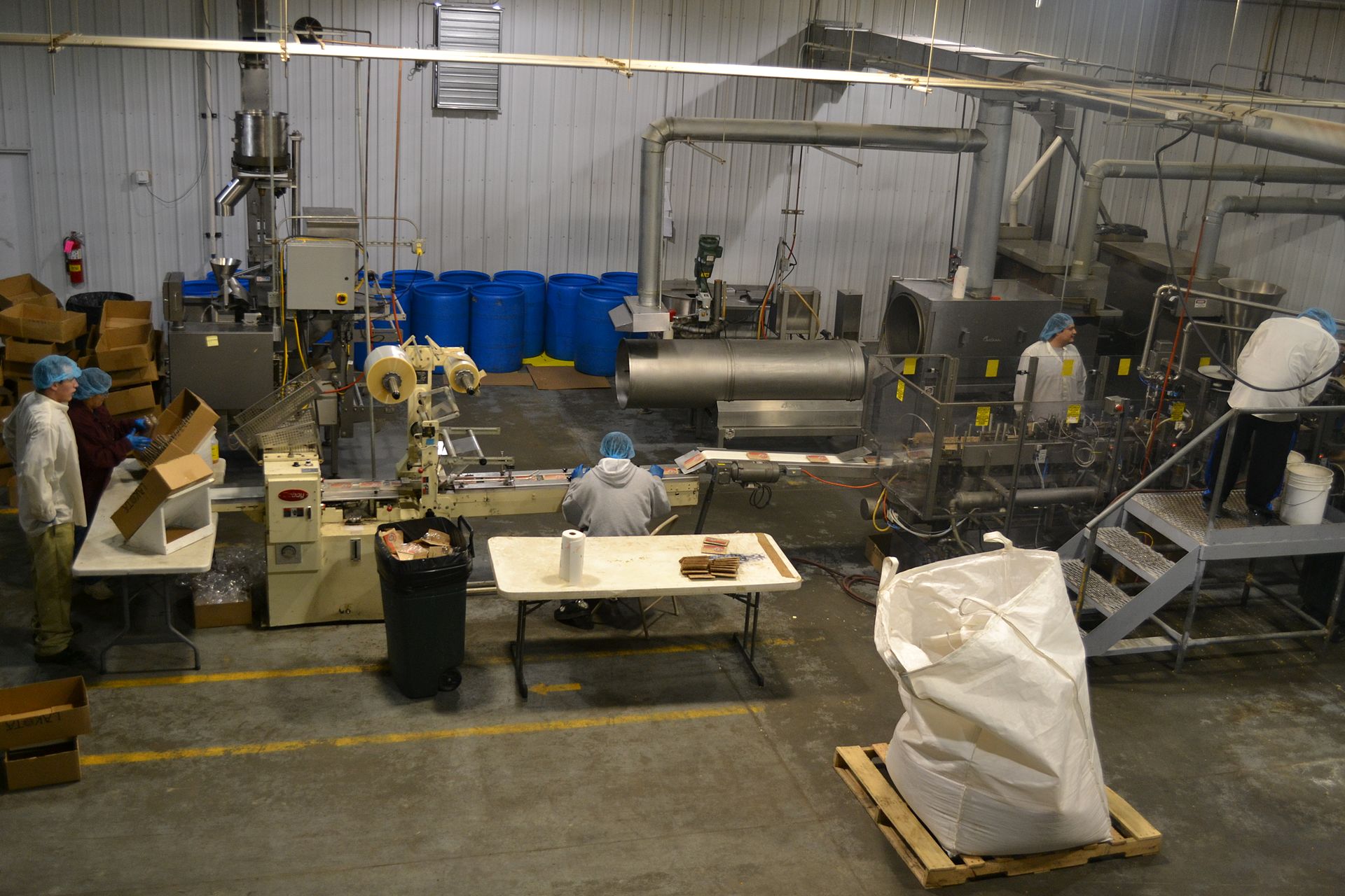 Stainless steel equipment and work stations inside a food processing plant.