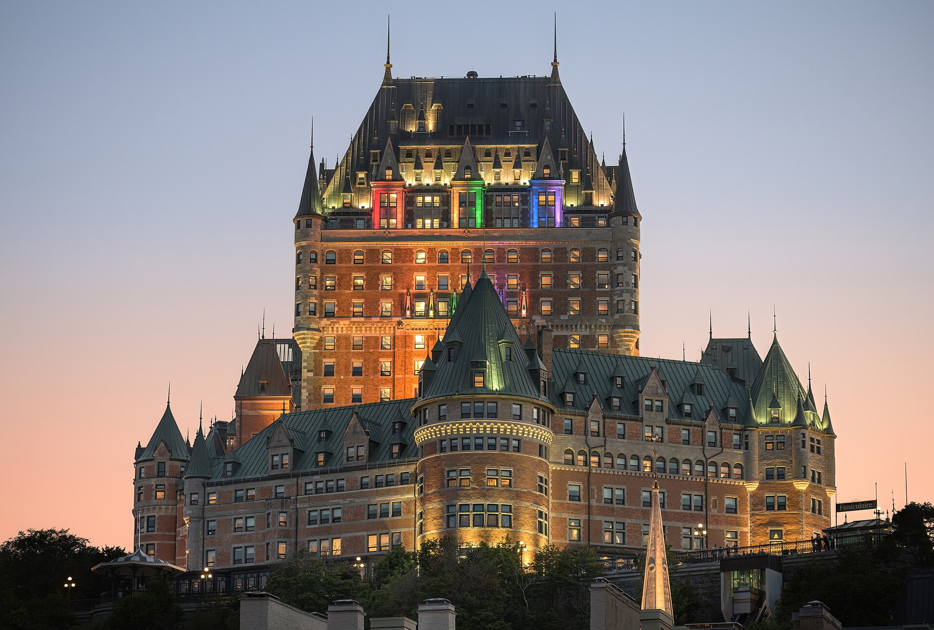 A large multi-story resort hotel building seen from outside at dusk.
